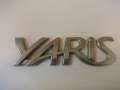 Эмблема (логотип YARIS) 11,0 х 3,0 мм.  Toyota Yaris (P90)