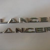 Эмблема на крышку багажника (логотип LANCER) 7415A112