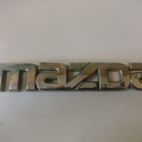 Эмблема на крышку багажника (логотип MAZDA) G21B51711