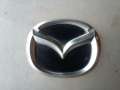Эмблема на корпус воздушного фильтра L323102D9 Mazda 6 (GG)